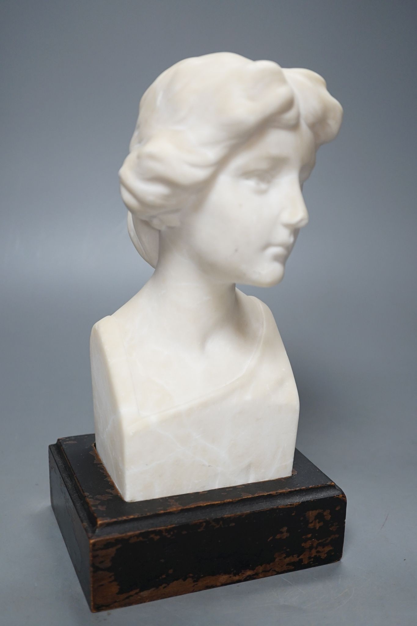 An alabaster head of a woman on plinth 25cm